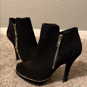 Sleek Black Heeled Boots with Gold Zipper